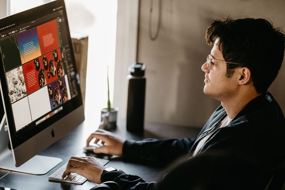 Designer working on ad creative on a large monitor
